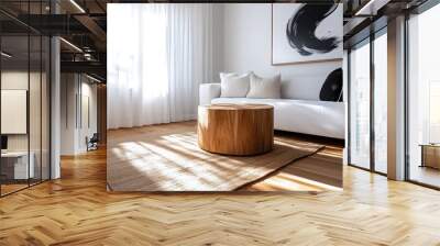 A cozy living room featuring a plush white sofa, a round wooden table, and an abstract art piece, all bathed in soft natural light from a nearby window. Wall mural