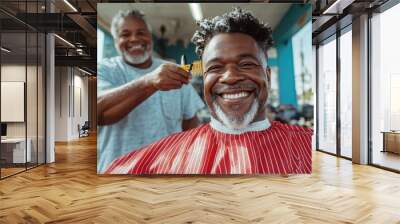 A man sits at the barber smiling widely while getting a haircut, capturing joy and relaxation in a colorful and lively atmosphere of a vibrant barbershop. Wall mural