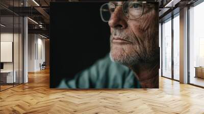 This image reveals a person wearing glasses, capturing a moment of focused intent and contemplation, with fine details highlighting the facial features and thoughtful expression. Wall mural