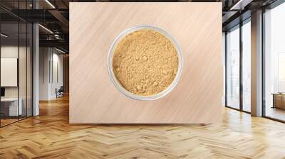 Top view of an open jar of ground ginger root powder. Wall mural