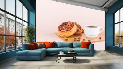 Two sweet cinnamon rolls and a cup of coffee. Wall mural