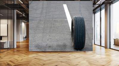 Car tire on the road Wall mural