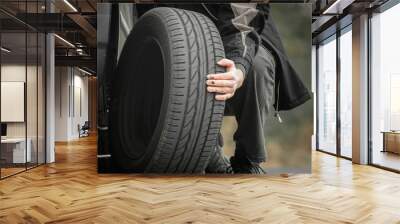 Young man repairing car outdoors Wall mural