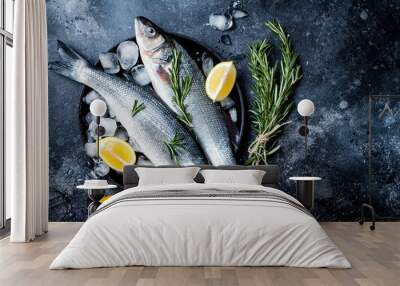 Fresh raw seabass fish on black stone background with spices, herbs, lemon. Culinary seafood background with ingredients for cooking. Top view Wall mural