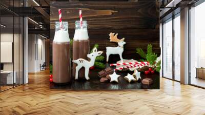 Hot chocolate with whipped cream in old-fashioned retro bottles with red striped straws. Christmas holiday drink and gingerbread baby deer or fawn cookies. Free text copy space Wall mural