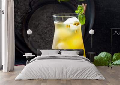 Passionfruit iced green tea or lemonade with lime and mint. Tropical refreshing cold drink for summer Wall mural