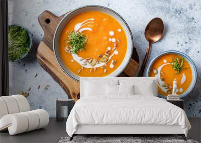 Vegetarian autumn pumpkin and carrot soup with cream, seeds and cilantro micro greens. Comfort food, fall and winter healthy slow food concept Wall mural