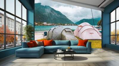 Camping tents on the coast of the alpine lake in Bavaria, Germany. Outdoor vacation in the mountains. Tourism in Europe. Wall mural