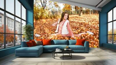 Autumn portrait of adorable smiling little girl child preteen having fun in the park Wall mural