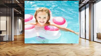 Pretty little girl in swimming pool Wall mural