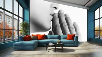 Black and white image of  a  woman  during a prayer on white background. Her hands touchs  a lips. Wall mural