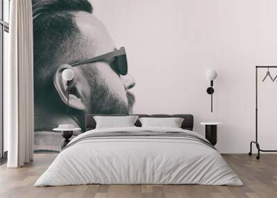 Black and white portrait of a bearded man with a stylish haircut. Wall mural