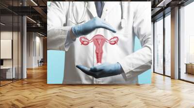 Image of a doctor in a white coat and model of the reproductive system of women above his hands. Concept of a healthy female reproductive system. Wall mural