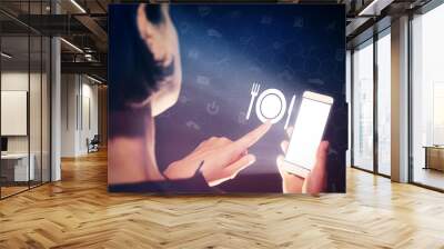 image of a girl with a smartphone in hands. she presses on the restaurant icon. concept of modern te Wall mural