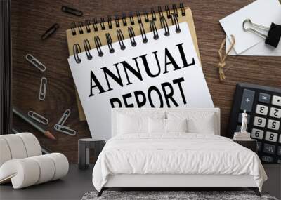 ANNUAL REPORT. two notebooks with a spring on a wooden background with a pencil calculator pen business concept. Office concept. Wall mural