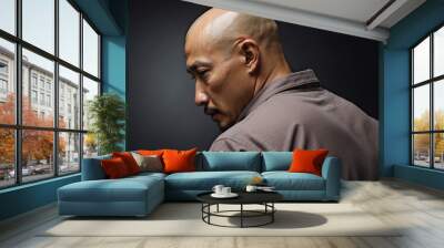 Bald Asian man on dark background Wall mural