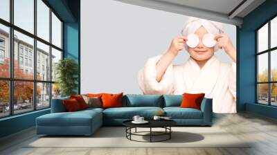 Banner view of beautiful kid girl with towel on head hold cotton pad disk cleansing face skin with cleanser. Happy girl remove makeup enjoy healthy clean skincare beauty treatment concept Wall mural