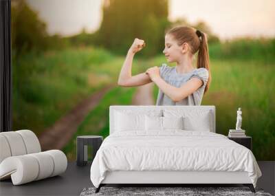 Child cute girl show biceps gesture of power and strength outdoor. Feel so powerful. Girls rules concept. Wall mural