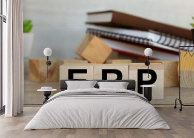 Enterprise Resource Management ERP . text on wooden cubes. wood blocks are stacked in two rows. in the background notepad and plants Wall mural