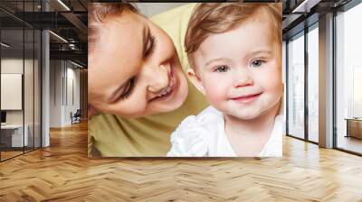 Mother and baby playing and smiling. Happy family.Home interior. Wall mural