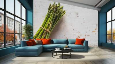 Fresh green spring asparagus on a wooden background. Asparagus season Wall mural