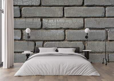 Gray brick wall background. The texture of the old brick wall is horizontal. Cracks form a beautiful mesh Wall mural