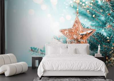 Christmas fir tree branches with golden star decoration  on blurred blue background. Christmas and Winter concept. Wall mural