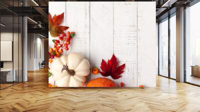 Festive autumn decor from pumpkins, berries and leaves on a white  wooden background. Concept of Thanksgiving day or Halloween. Flat lay autumn composition with copy space. Wall mural