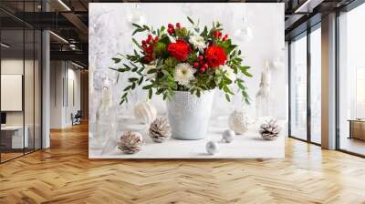 Festive winter flower arrangement with red roses, white chrysanthemum and berries in vase on table. Christmas decorations  for holiday. Wall mural