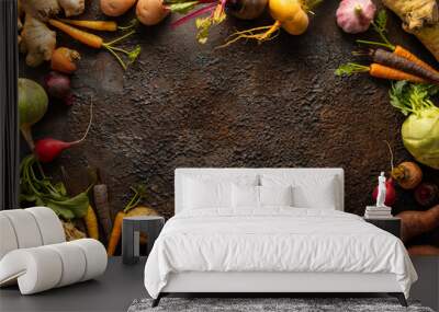 Food frame of raw Vegetables and root vegetables on textured background. Autumn harvest. Healthy food and vegetarian concept. Wall mural