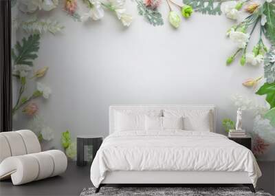 White flowers  and silver-green leaves  on pastel grey background. Flowers composition with copy space, flat lay. Wall mural