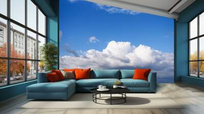 Blue bright sky with many sunny clouds. Wall mural