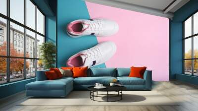 Flat lay of sport sneakers shoes on the blue and pink background. Fitness background. Healthy lifestyle concept. Wall mural