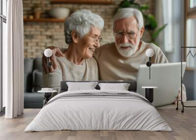 Happy family at the laptop computer. Smiling elderly senior man and woman, husband and wife Wall mural