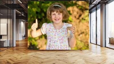 Little girl kid with glass of water in morning, drink every day. Concept of healthy habits Wall mural