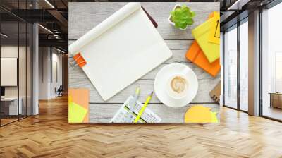 open notepad, coffee cup, yellow and orange notepad and calendar on wooden background, spiral notepad on table Business, planning, education, morning life, work from home, concept Top view Flat mockup Wall mural