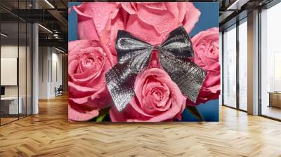 Pink roses with drops of dew on a blue background. The view from the top . The concept of Valentine's Day Wall mural