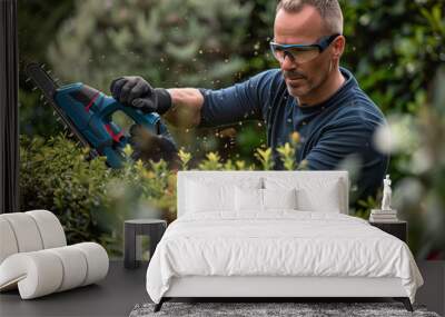 product photography of a man using powerful and imposing garden power tool, a cordless hedge trimmer with a long blade to cut the top of green hedges in a mid size modern house garden Wall mural