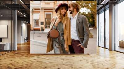 Close up portrait of amazing stylish couple in love  spending  romantic holidays in European city. Pretty blond woman in hat and casual dress smiling and looking on her handsome man with beard. Wall mural