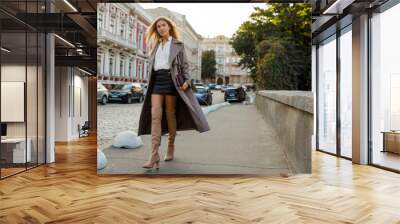 Fashion full length image of elegant  blond  woman in stylish luxury beige leather  coat and hight heels, walking  outdoor. Autumn fashion look. Wall mural