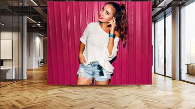 Fashionable   shaming   girl in trendy  street style outfit posing on pink urban wall. Flash. Wall mural