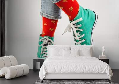 Stylish, bright, green sneakers and funny, happy socks on a white background. Sport, style, beauty, good mood Wall mural