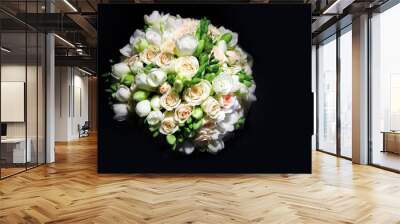 The bride's bouquet on a black background is one. wedding bouquet and two gold rings, the rings are on the flower buds in the bouquet. Wall mural