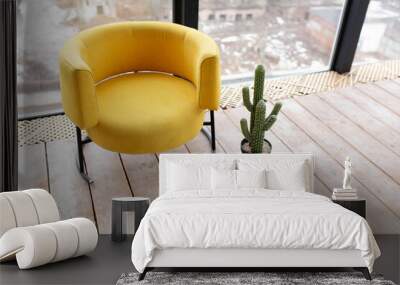 the yellow chair in the corner of a white room. Wall mural