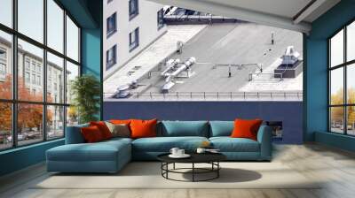 Top view gray flat roof with air conditioners and hydro insulation membranes on top of a modern apartment building. Wall mural