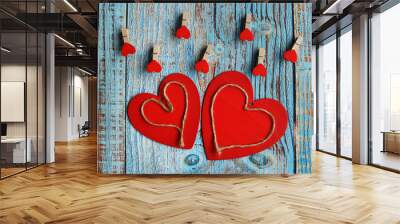 Two wooden red hearts are beautifully placed on a turquoise vintage wooden one. valentine card. hearts on a clothespin Wall mural