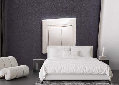 White light switch on dark gray wall. Light on and off buttons Wall mural