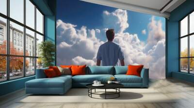 young man on the clouds. the guy died and went to heaven and smiles. man looks at the sky. life after death Wall mural