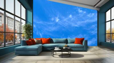 gentle white clouds in a bright blue sky Wall mural