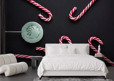 Christmas candy cane, mint marshmallow on black background. Christmas background. Top view and copy space. Wall mural